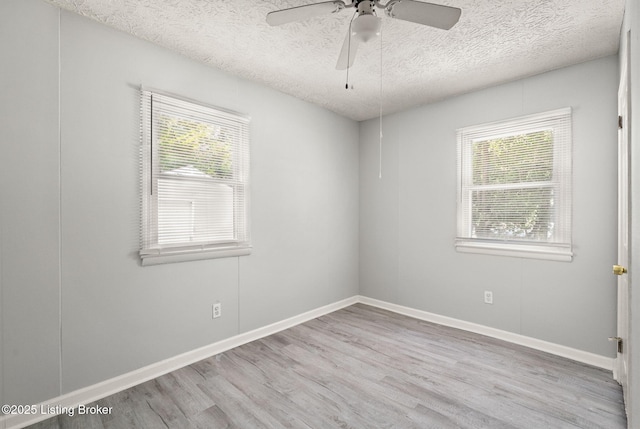 6614 Putman St, Louisville, KY 40216 - unfurnished room with healthy amount of natural light, wood finished floors, a textured ceiling, ceiling fan, and baseboards
