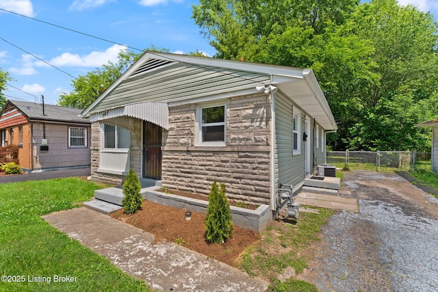 1037 Kaiser Ct, Louisville, KY 40211 - bungalow featuring stone siding and asphalt driveway