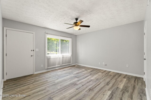 1037 Kaiser Ct, Louisville, KY 40211 - spare room with a ceiling fan, wood finished floors, a textured ceiling, and baseboards