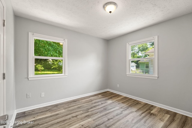 1037 Kaiser Ct, Louisville, KY 40211 - empty room featuring wood finished floors, a textured ceiling, and baseboards