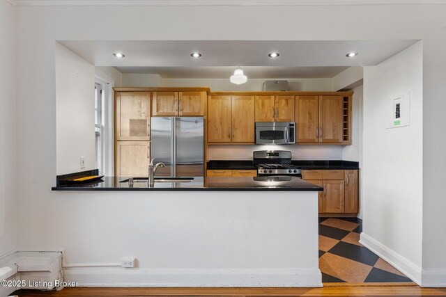 1412 Willow Ave Unit 69, Louisville, KY 40204 - kitchen featuring appliances with stainless steel finishes, dark countertops, baseboards, a sink, and tile patterned floors