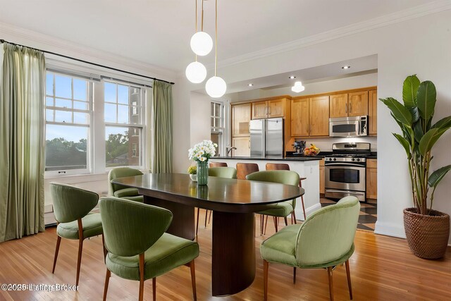 1412 Willow Ave Unit 69, Louisville, KY 40204 - dining area featuring crown molding and light wood-style floors