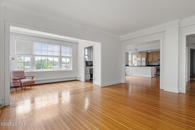 1412 Willow Ave Unit 69, Louisville, KY 40204 - unfurnished living room with a baseboard heating unit, crown molding, light wood finished floors, and baseboards