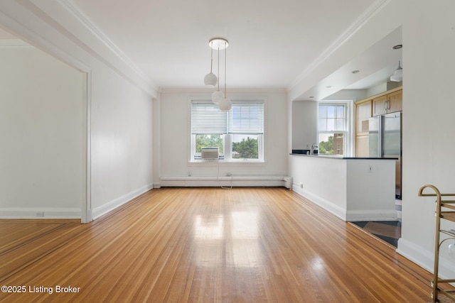 1412 Willow Ave Unit 69, Louisville, KY 40204 - unfurnished room featuring a baseboard heating unit, healthy amount of natural light, crown molding, light wood-style floors, and baseboards