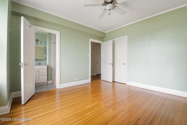 1412 Willow Ave Unit 69, Louisville, KY 40204 - unfurnished bedroom with light wood-style floors, baseboards, crown molding, and connected bathroom
