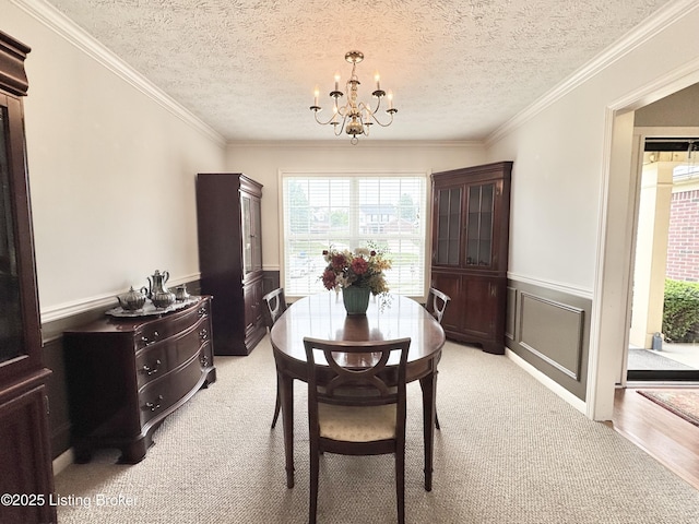 10923 Collington Dr, Louisville, KY 40241 - dining area featuring wainscoting, healthy amount of natural light, a chandelier, light colored carpet, and crown molding
