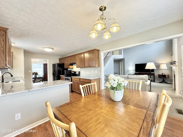 10923 Collington Dr, Louisville, KY 40241 - dining space with a chandelier, light wood-type flooring, and a textured ceiling