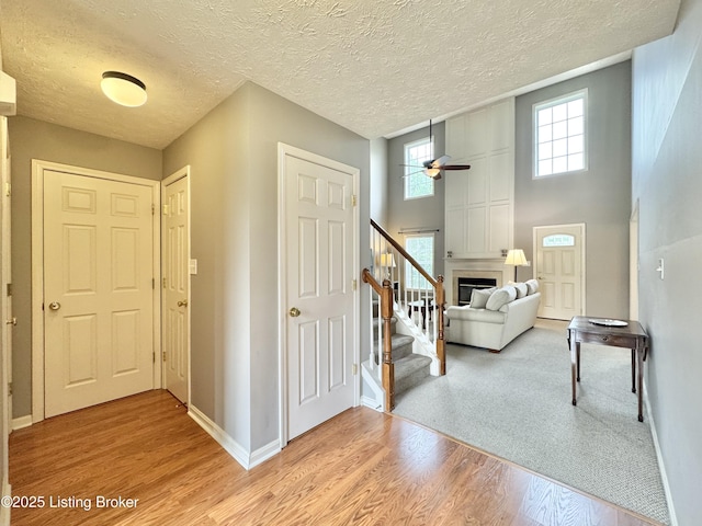 10923 Collington Dr, Louisville, KY 40241 - foyer entrance featuring ceiling fan, light wood finished floors, baseboards, a fireplace, and stairs