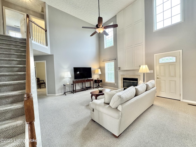 10923 Collington Dr, Louisville, KY 40241 - carpeted living area featuring high vaulted ceiling, stairway, baseboards, a large fireplace, and a ceiling fan