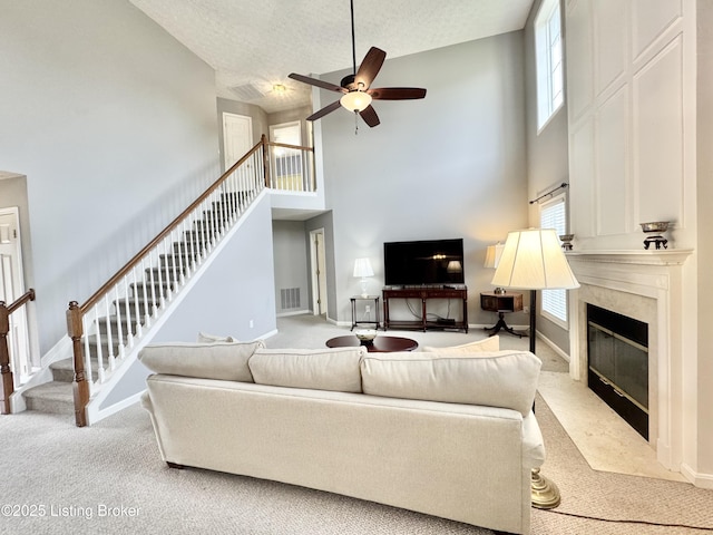 10923 Collington Dr, Louisville, KY 40241 - carpeted living area featuring a towering ceiling, healthy amount of natural light, a fireplace, stairs, and ceiling fan