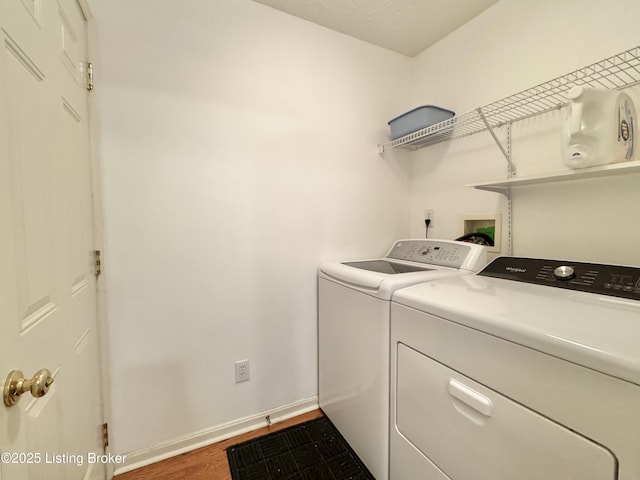 10923 Collington Dr, Louisville, KY 40241 - laundry area with washing machine and dryer, wood finished floors, and baseboards