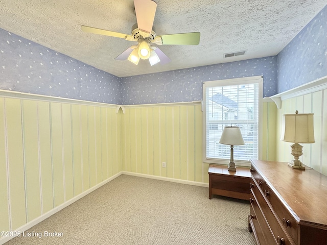 10923 Collington Dr, Louisville, KY 40241 - carpeted empty room with wallpapered walls, a textured ceiling, a wainscoted wall, and ceiling fan
