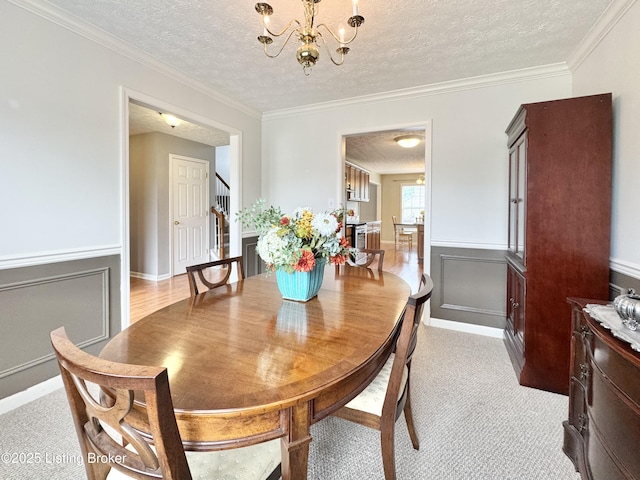 10923 Collington Dr, Louisville, KY 40241 - dining space with a textured ceiling, stairway, a chandelier, ornamental molding, and wainscoting