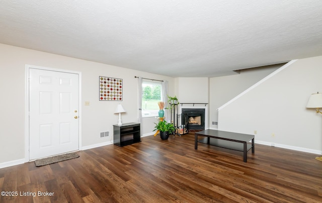 10600 Colonial Woods Way Unit 9-1, Louisville, KY 40223 - living area with wood finished floors, a fireplace, a textured ceiling, and baseboards