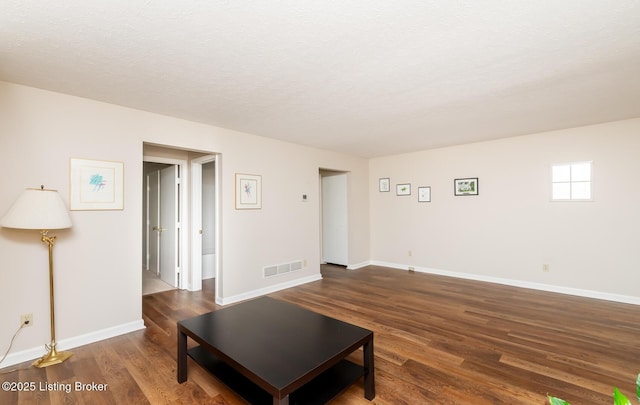 10600 Colonial Woods Way Unit 9-1, Louisville, KY 40223 - living area with wood finished floors, baseboards, and a textured ceiling