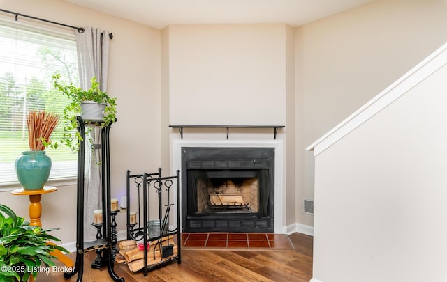 10600 Colonial Woods Way Unit 9-1, Louisville, KY 40223 - detailed view of wood finished floors, a fireplace with flush hearth, and baseboards