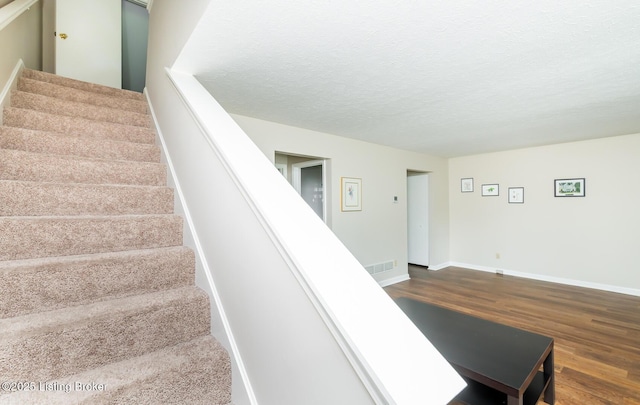 10600 Colonial Woods Way Unit 9-1, Louisville, KY 40223 - stairs with wood finished floors, a textured ceiling, and baseboards