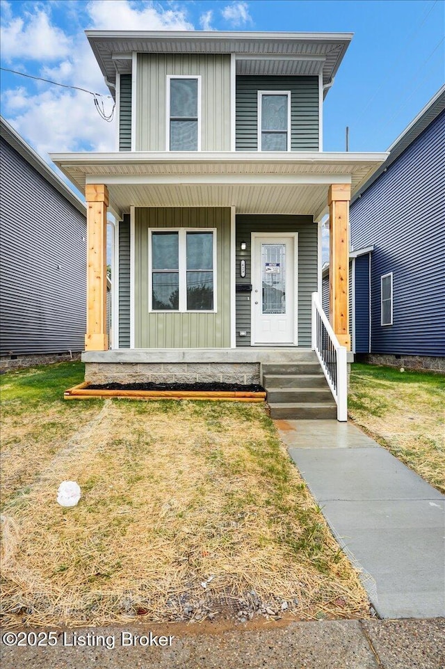 629 S 19th St, Louisville, KY 40203 - view of front facade with board and batten siding, covered porch, and a front lawn
