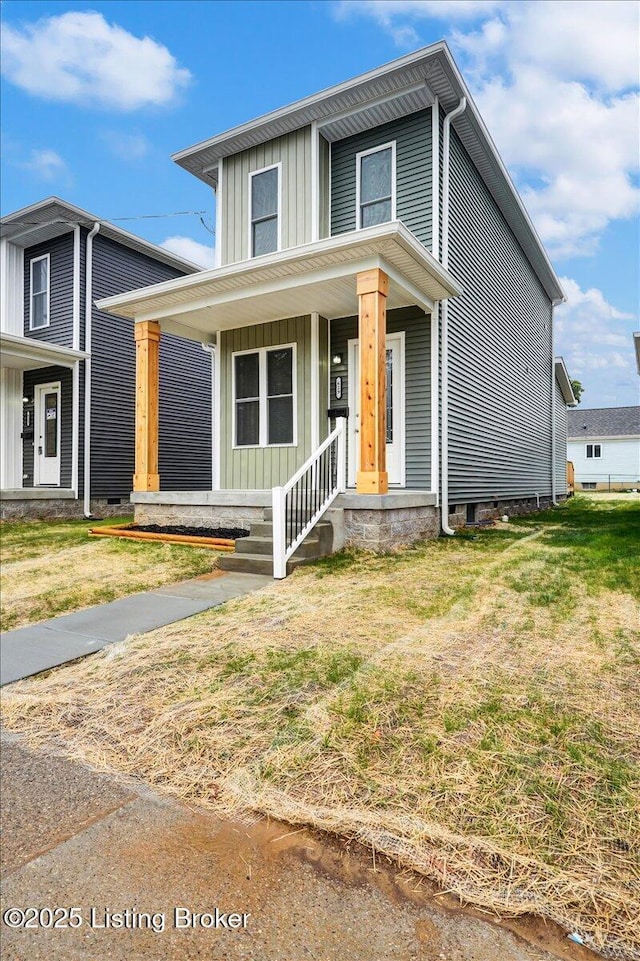 629 S 19th St, Louisville, KY 40203 - view of front of house featuring board and batten siding, covered porch, and a front lawn