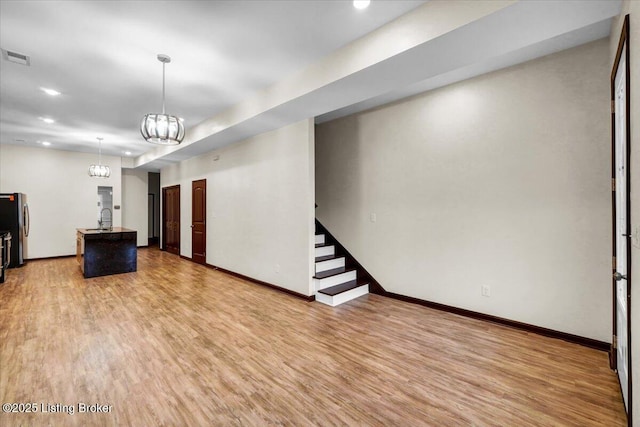 629 S 19th St, Louisville, KY 40203 - unfurnished living room featuring light wood-type flooring, baseboards, stairway, a chandelier, and recessed lighting