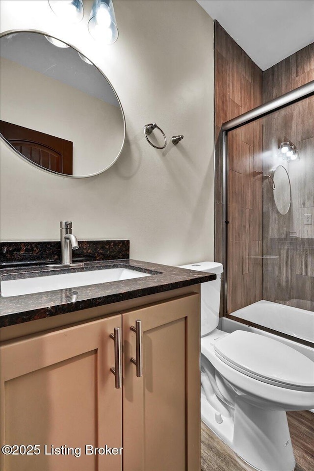 629 S 19th St, Louisville, KY 40203 - full bathroom with vanity, toilet, a shower with door, and wood finished floors