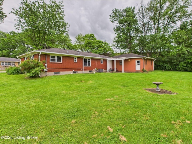 4212 David Ave, Louisville, KY 40215 - rear view of property featuring a lawn, brick siding, and a patio area