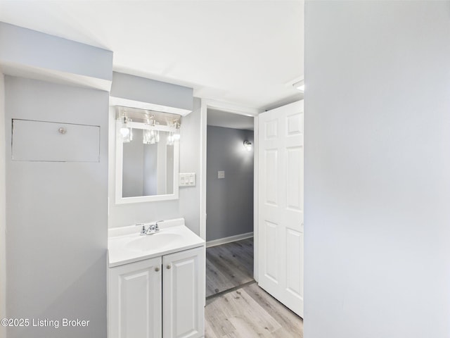 4212 David Ave, Louisville, KY 40215 - bathroom featuring wood finished floors, vanity, and baseboards