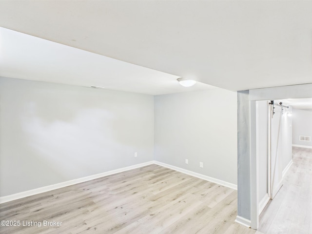 4212 David Ave, Louisville, KY 40215 - finished basement featuring wood finished floors, baseboards, and a barn door