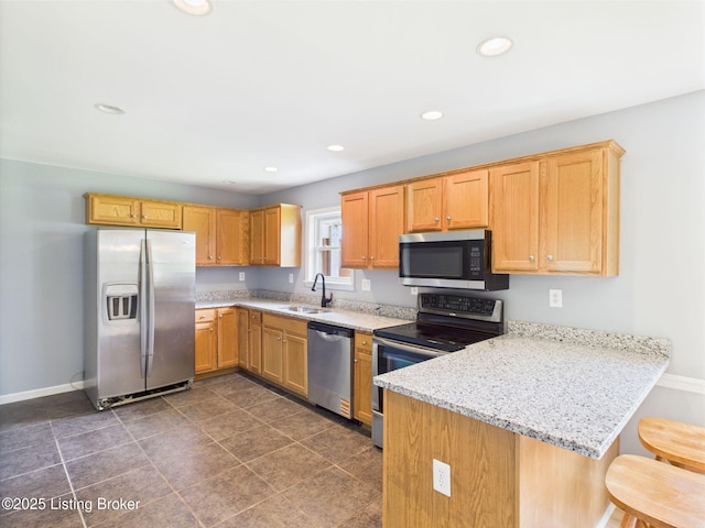 4212 David Ave, Louisville, KY 40215 - kitchen with appliances with stainless steel finishes, a sink, a peninsula, baseboards, and light stone countertops