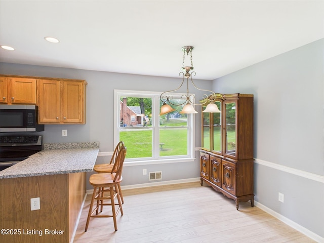 4212 David Ave, Louisville, KY 40215 - dining area with recessed lighting, light wood-type flooring, and baseboards
