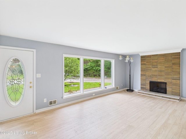 4212 David Ave, Louisville, KY 40215 - unfurnished living room with light wood finished floors, a large fireplace, and baseboards