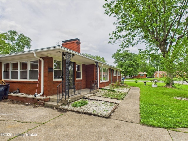 4212 David Ave, Louisville, KY 40215 - view of front of property featuring a chimney, brick siding, and a front lawn