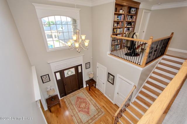 18705 Weymuth Ln, Louisville, KY 40245 - foyer entrance with wood finished floors, a chandelier, stairway, a towering ceiling, and crown molding