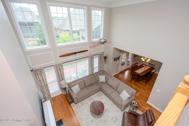 18705 Weymuth Ln, Louisville, KY 40245 - living room featuring wood finished floors, ceiling fan, crown molding, and a high ceiling