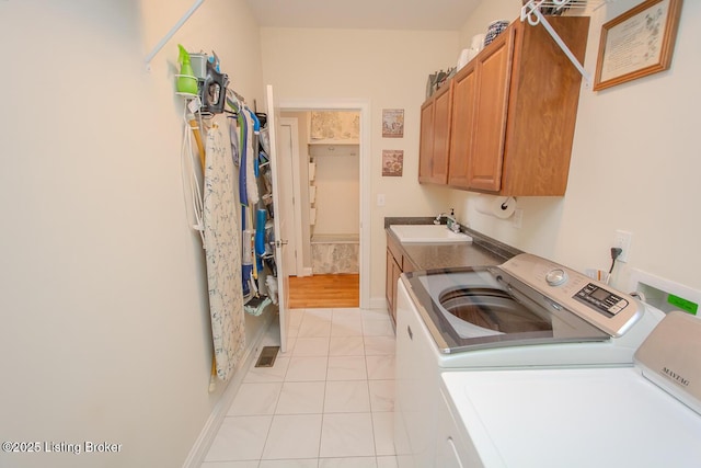 18705 Weymuth Ln, Louisville, KY 40245 - laundry room featuring washing machine and clothes dryer, cabinet space, light tile patterned floors, and baseboards