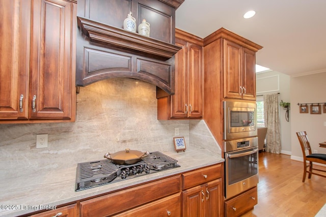 18705 Weymuth Ln, Louisville, KY 40245 - kitchen with stainless steel appliances, decorative backsplash, light countertops, light wood-style floors, and brown cabinets