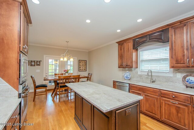 18705 Weymuth Ln, Louisville, KY 40245 - kitchen featuring a sink, stainless steel appliances, light wood-type flooring, tasteful backsplash, and a center island
