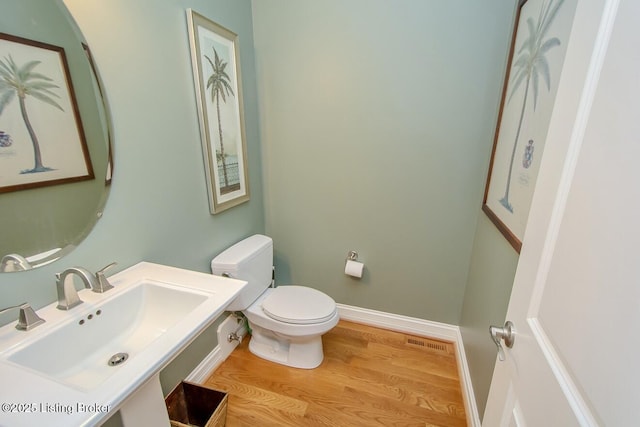 18705 Weymuth Ln, Louisville, KY 40245 - bathroom with a sink, toilet, wood finished floors, and baseboards