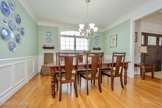 18705 Weymuth Ln, Louisville, KY 40245 - dining room featuring light wood-type flooring, a wainscoted wall, crown molding, a chandelier, and a decorative wall