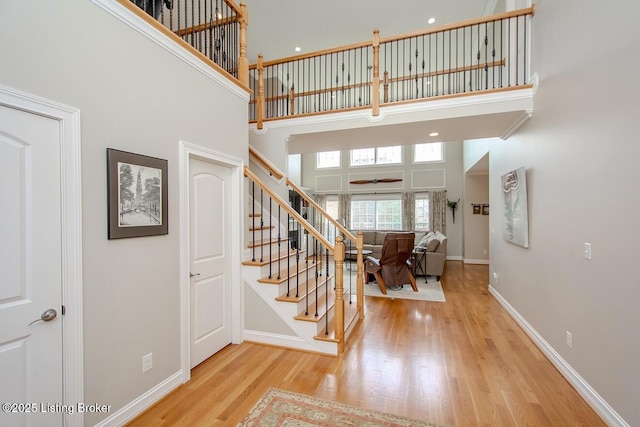 18705 Weymuth Ln, Louisville, KY 40245 - stairway featuring a towering ceiling, wood finished floors, and baseboards