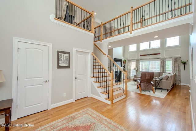 18705 Weymuth Ln, Louisville, KY 40245 - stairway with a high ceiling, wood finished floors, ceiling fan, and baseboards
