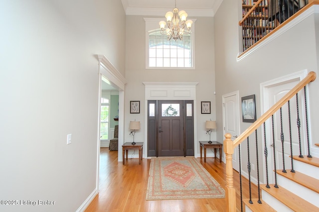 18705 Weymuth Ln, Louisville, KY 40245 - entryway with light wood-type flooring, a chandelier, a high ceiling, stairway, and baseboards