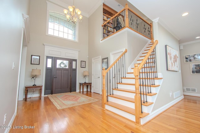 18705 Weymuth Ln, Louisville, KY 40245 - foyer entrance featuring a chandelier, ornamental molding, wood finished floors, stairs, and baseboards