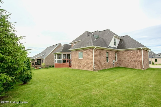 18705 Weymuth Ln, Louisville, KY 40245 - back of property with a sunroom, a shingled roof, brick siding, and a yard