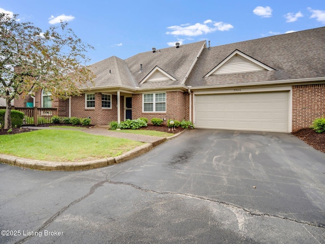 7906 Tuckaway Ct, Louisville, KY 40291 - view of front facade featuring asphalt driveway, brick siding, an attached garage, a front yard, and roof with shingles