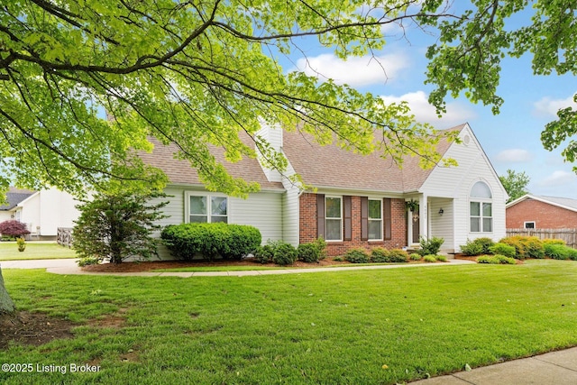 view of front of property with brick siding and roof with shingles