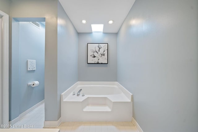 bathroom with a bath, baseboards, and recessed lighting