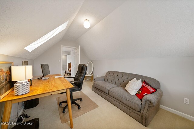 carpeted home office featuring a skylight, vaulted ceiling, baseboards, and a textured ceiling