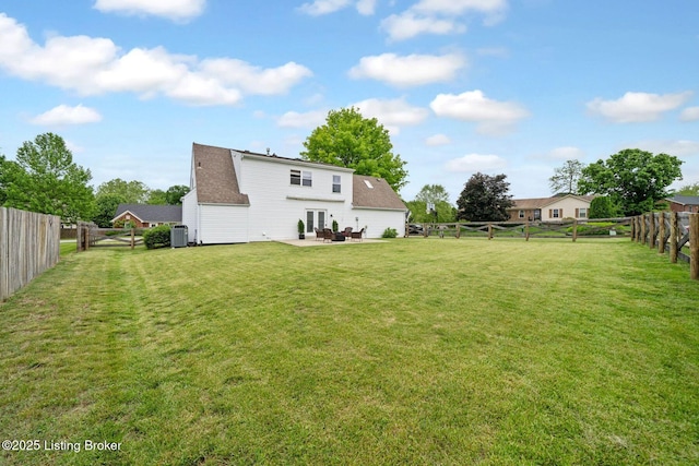 view of yard with a patio, central AC, and french doors