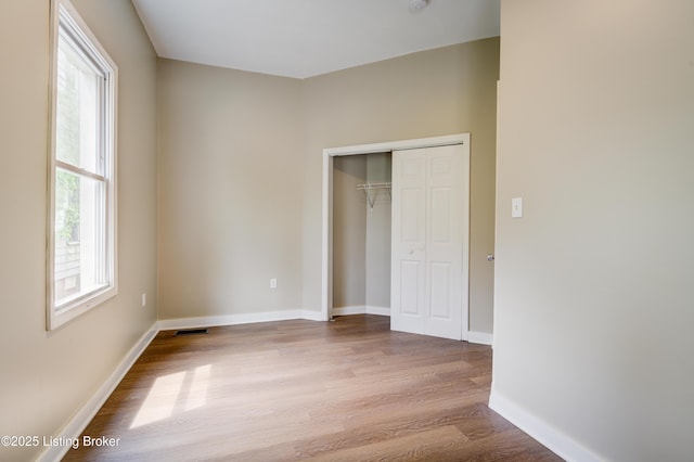 474 N 29th St, Louisville, KY 40212 - unfurnished bedroom with wood finished floors, a closet, and baseboards